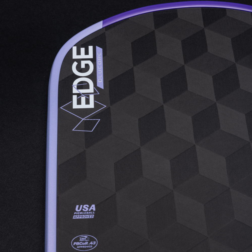Close-up of a black and purple sports equipment with 'EDGE' branding on a dark background
