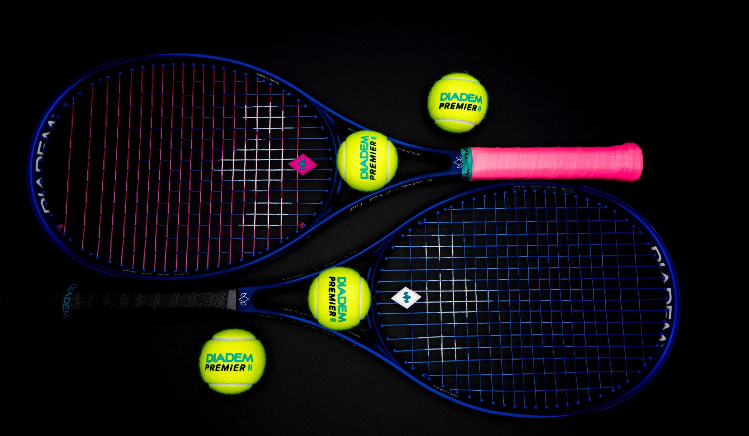 tennis racket and balls laying flat on black background