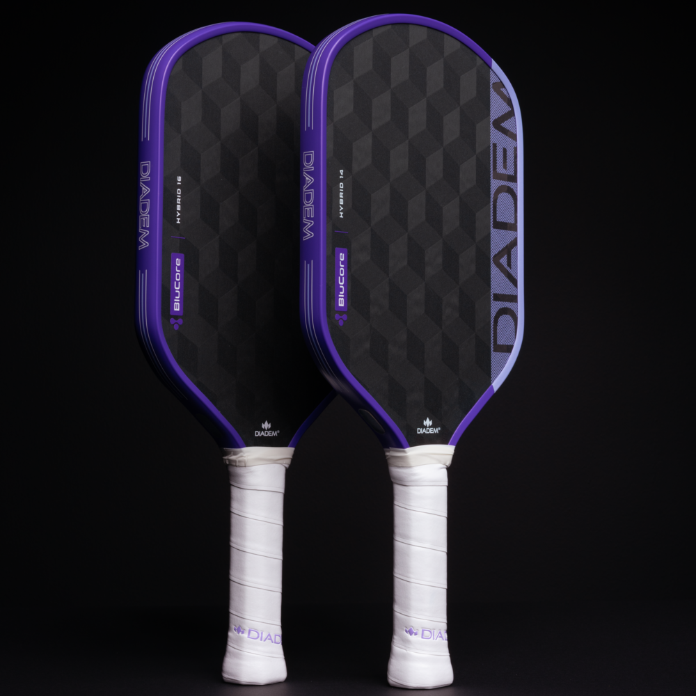 Two pickleball paddles with purple and black design on a black background