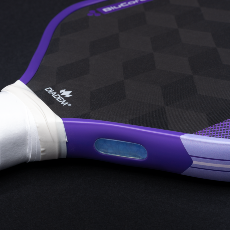 Close-up of a purple and white flashlight on a black background