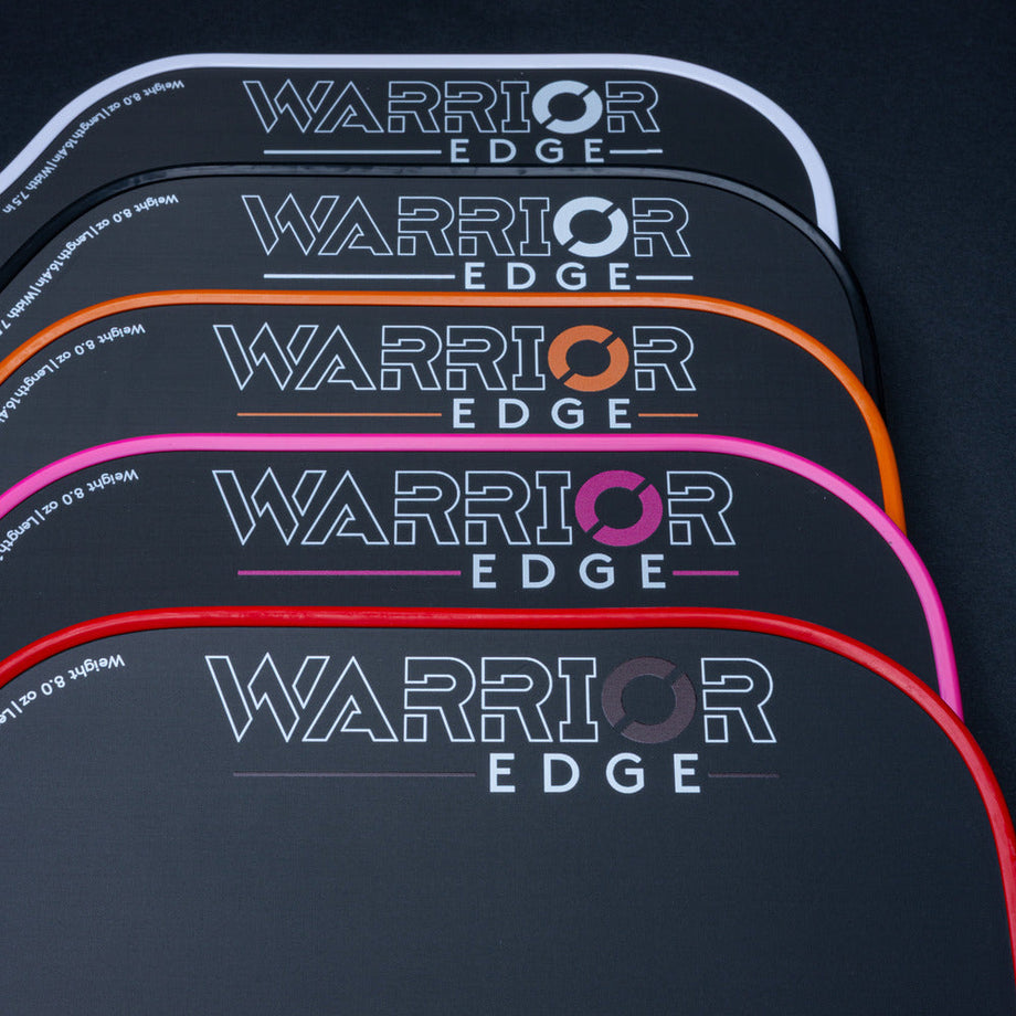 Stack of Warrior Edge products with colorful branding on a dark background