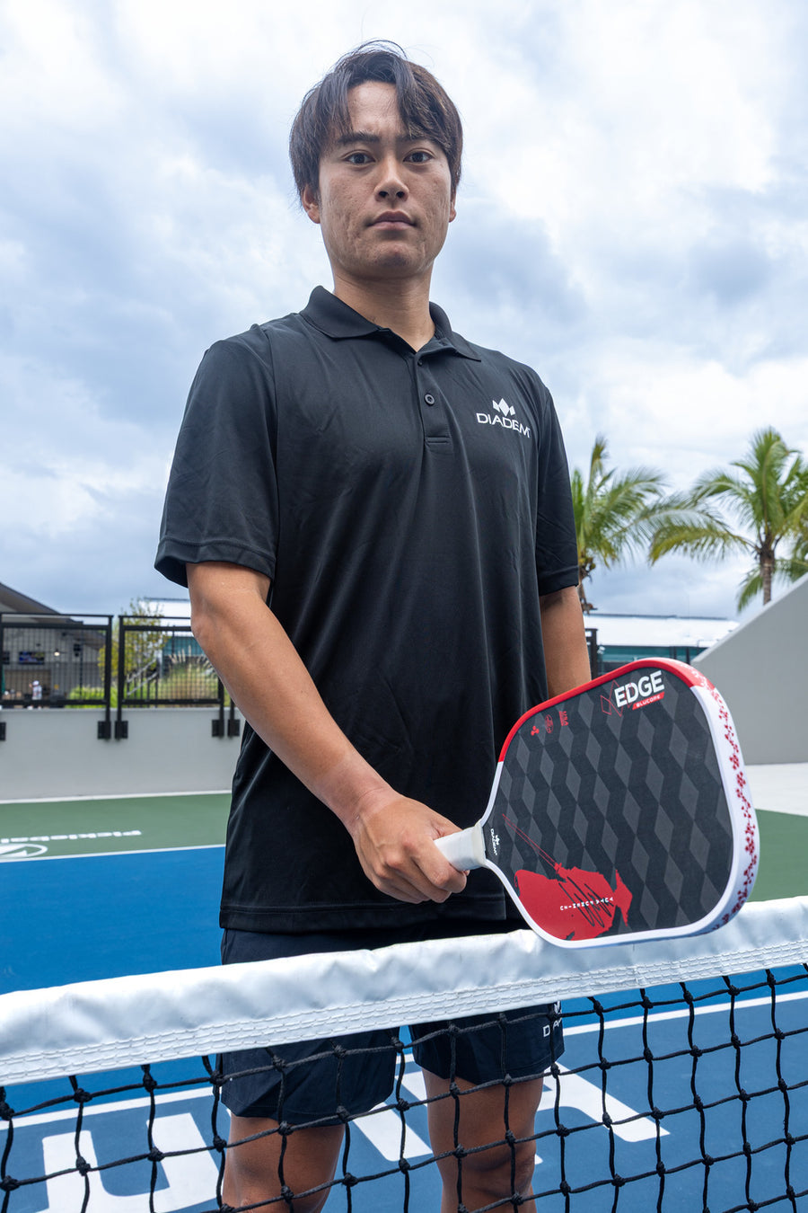 Yuta Funemizu at the net holding his Diadem Edge pickleball paddle
